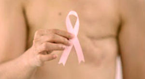 Mastectomy image  holding a pink ribbon on a blurred background